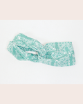 Light mint green turban headband with Sabah motif by Changgih Designs lay on white background